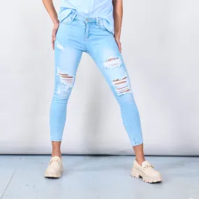 Distressed skinny jeans with ripped details wholesale